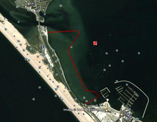 The red line shows the proposed course we would aim to take. We would tow SR2 to the beach at upper left and raise the wing there. SR2 would then be eased out and allowed to drift down-wind under the guidance of the support rib. Once clear of the shore she would be released and I would try and get her started by sailing her back into the wind to create apparent wind and align all the wing sections. Once over her low speed drag hump and sailing back in towards the shore, I would control her speed © Paul Larsen
